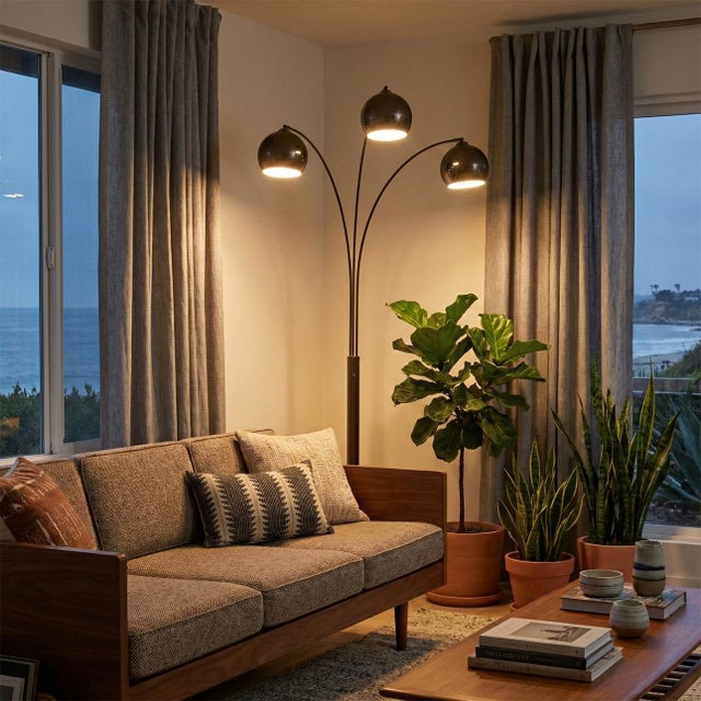 Originally designed by Peter Morelli in 1961, the Triplet Arc Floor Lamp is a timeless icon of mid-century modern design....