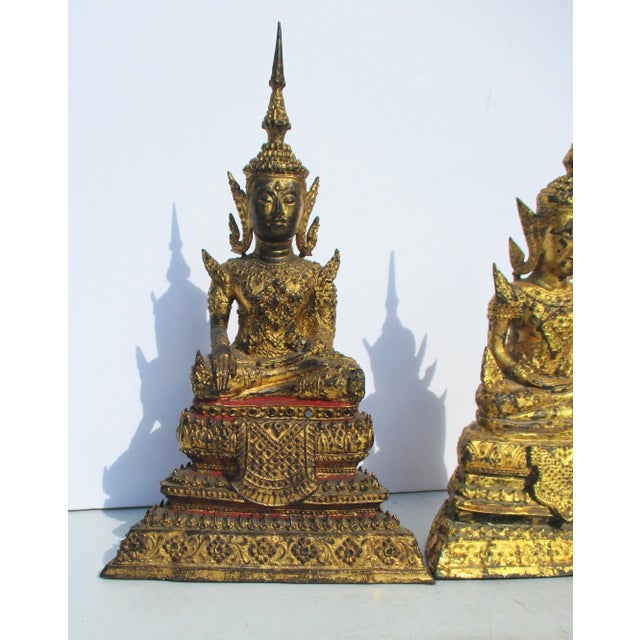 A vintage early 20th century Thai Bronze Buddha figures. A pair of similar size and form but completely different in...