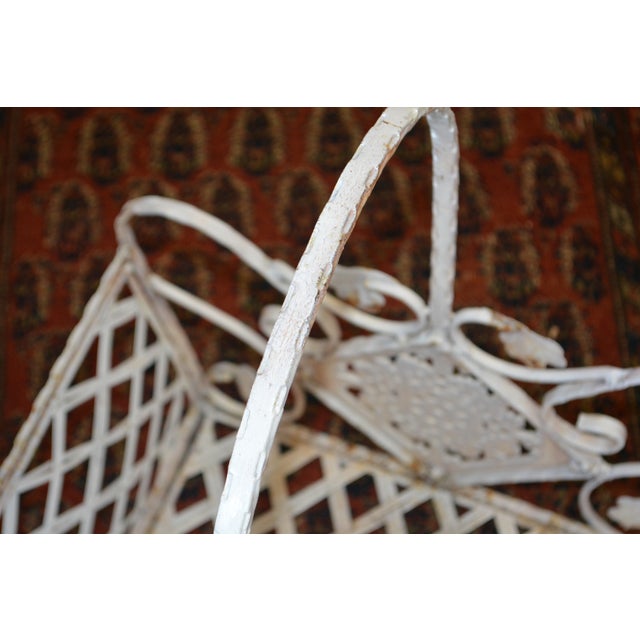 This is a great rustic/shabby chic iron basket. The 2 sides have, what appear to be, ornate iron tiles? Possibly from the...
