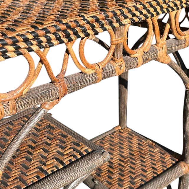 Constructed from hand-wrapped rattan poles in an intentional driftwood-grey finish, this petite étagère features a two-...