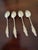 Beautiful antique set of four sterling silver teaspoons featuring an elegant grape-and-vine design. Each spoon is marked...