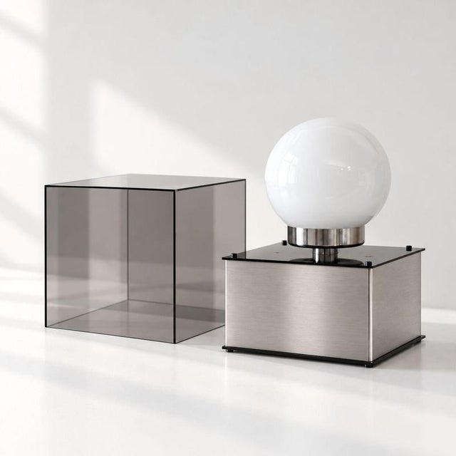 Italian table lamp from the 1970s, made of metal, Perspex, and opal glass and conceived in the New Lamp style. The...