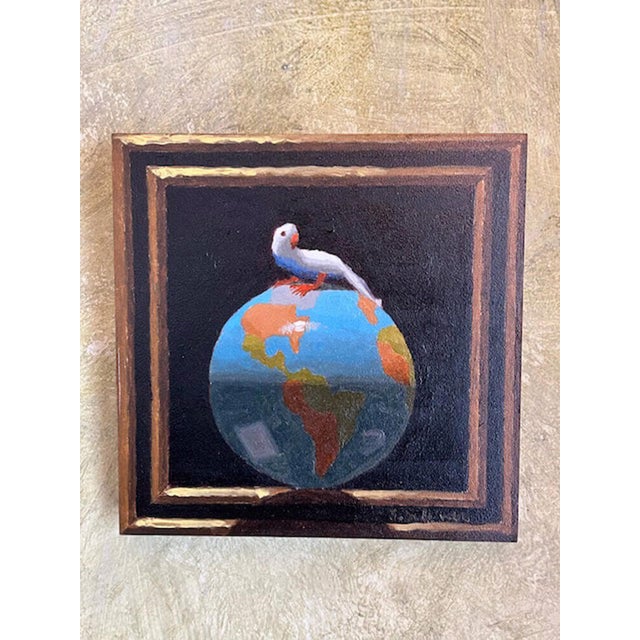 This oil on panel artwork features a bird perched atop a vividly painted globe, symbolizing a sense of global perspective...