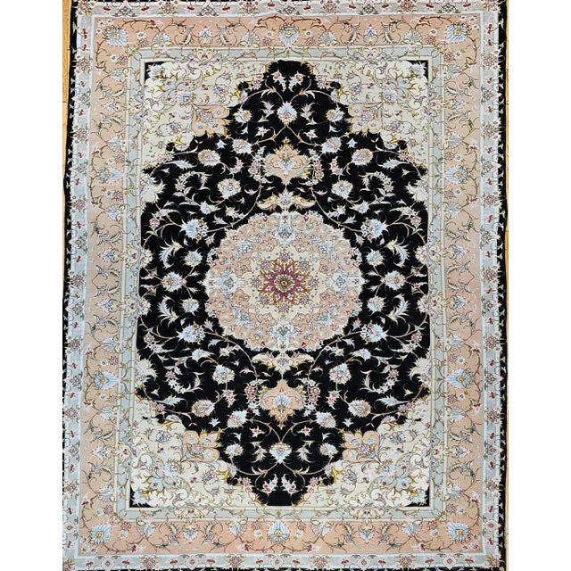 6’ 7” x 9’ 8” Rare and beautiful hand-knotted Persian Tabriz in a floral pattern in a black background with a brilliant...