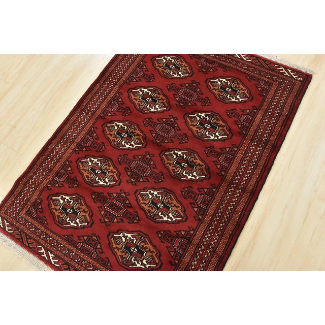 An authentic vintage tribal Turkmen rug hand-knotted with fine wool and natural dyes. This nomadic oriental rug features...