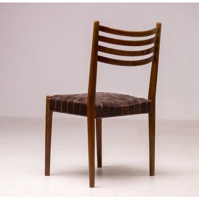 Dark stained beech chair with a webbed leather seating. The chair is attributed to Palle Suenson, as they come from the...