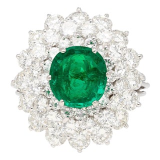 3.19 Carat Oval Cut Emerald Minor Oil & Diamond Cluster Platinum Vintage Ring For Sale