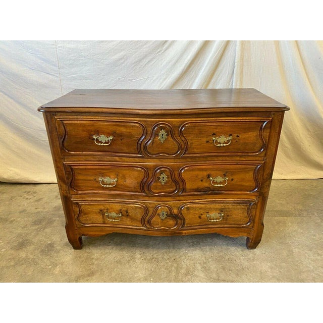 Beautiful 19th C French provencal walnut commode, all original with brass hardware pulls. This piece features deep carved...