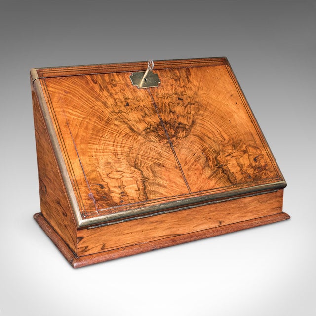 This is an antique admiral's writing station. An English, walnut and brass desktop correspondence or stationery case,...