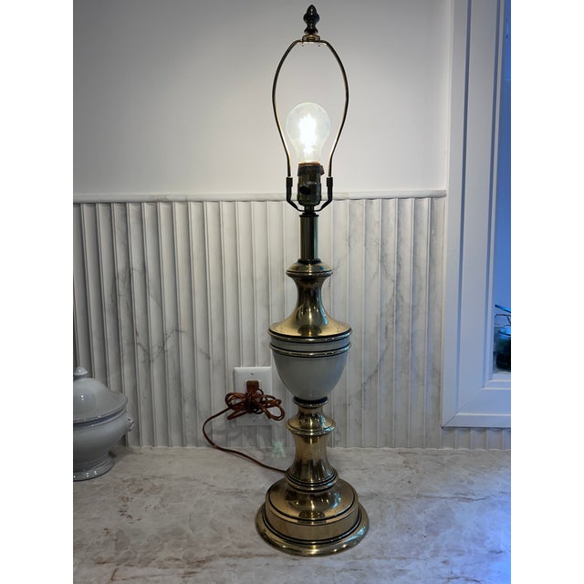 Hollywood Regency style table lamp, with a beautiful cream colored enamel, and black stripes adorn this heavy lamp. Made...