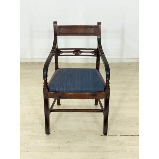 Four vintage dining chairs from the 1960s. The chairs impress with their classic design and high-quality mahogany wood....