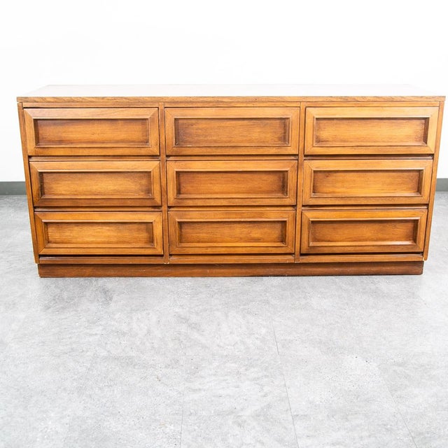 An outstanding wide / low dresser in walnut and walnut veneer by Morris of California. Hard to find style and design....