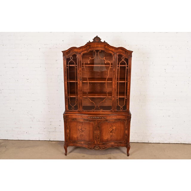 An exceptional French Provincial Louis XV style breakfront bookcase cabinet or dining cabinet By Romweber USA, Circa 1920s...