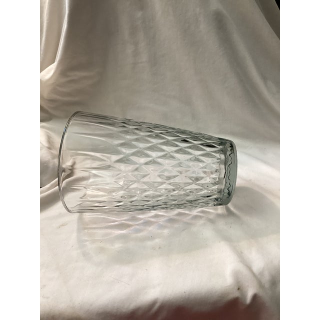 A classic vintage pressed glass vase featuring a bold diamond point pattern that catches lights beautifully. Its tall,...