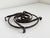 Rustic steel dimensional trivet or wall sculpture with abstract swirl pattern. Four feet lift the piece off the surface....