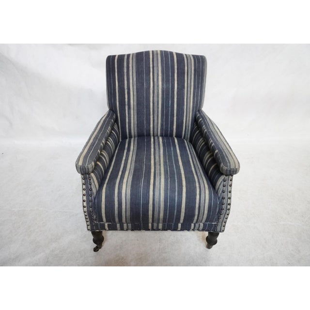 Blue Stripped Upholstered Armchair Upholstered in Cisco Home's organic stripped "Kayan Indigo" fabric, composed of a...