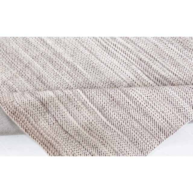This contemporary flat weave runner exudes quiet elegance through its minimalist design and finely crafted structure....