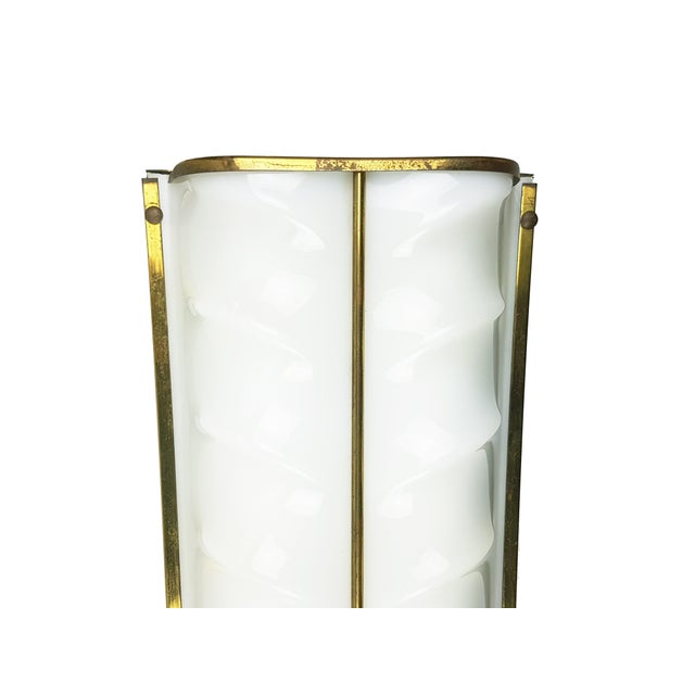 Large wall lamp (cm 68 height) produced in Italy around 1950. White/ivory metal body with brass and opaline acrylic glass...