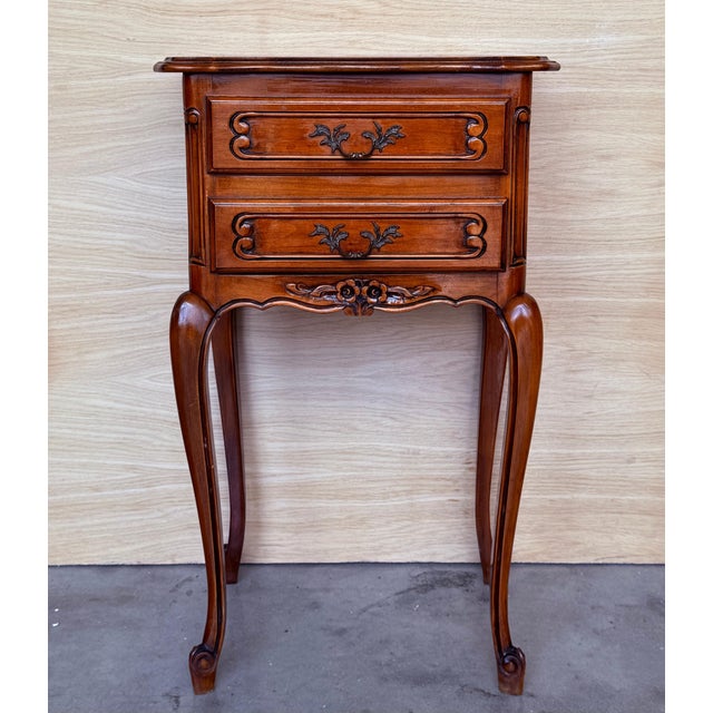 A fine pair of French bedside end tables or nightstands - each Stand featuring a scalloped edge gallery over a frieze of...