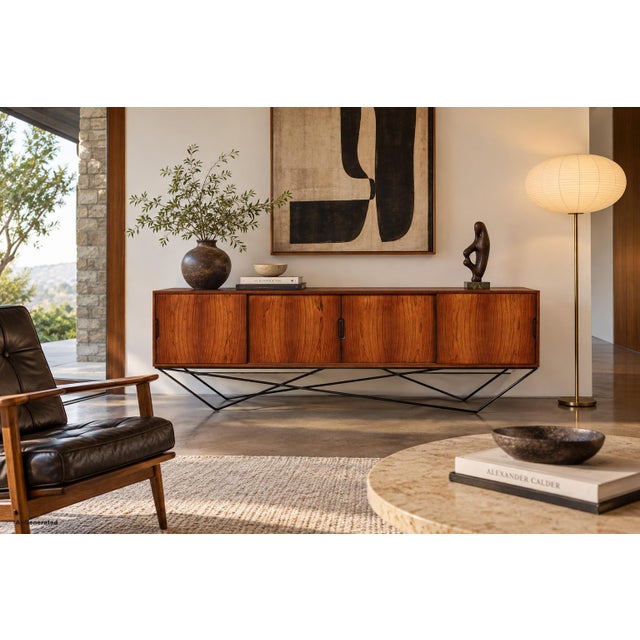 Designed by Knud Nielsen for Losning Mobelfabrik in the 1960s, this Danish modern credenza pairs exceptional Brazilian...