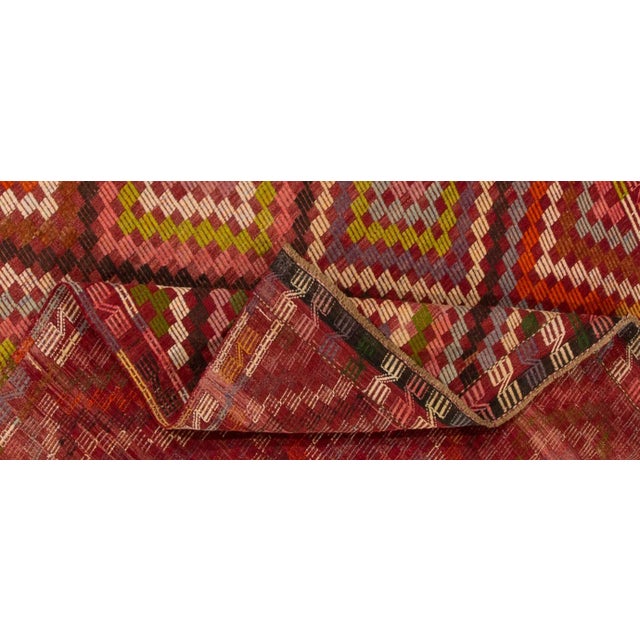 Beautiful vintage Turkish Kilim hand-knotted wool rug with a pink field. This piece has a multi-color accent in an all-...