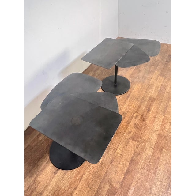 A pair of bench made steel fan tables in the manner of the French Constructivist Architect Pierre Chareau. His...