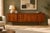 A striking 1960s walnut sideboard by British maker Greaves & Thomas. Featuring a long, low-profile design with beautifully...