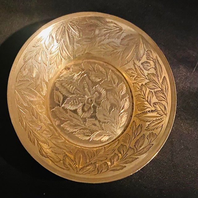 This set of vintage solid brass bowls showcases the exquisite hand-etched craftsmanship typical of traditional Indian...