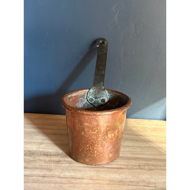 A hand-made French copper saucepan, sourced in Paris, with a long forged iron handle. The pan was made the traditional...