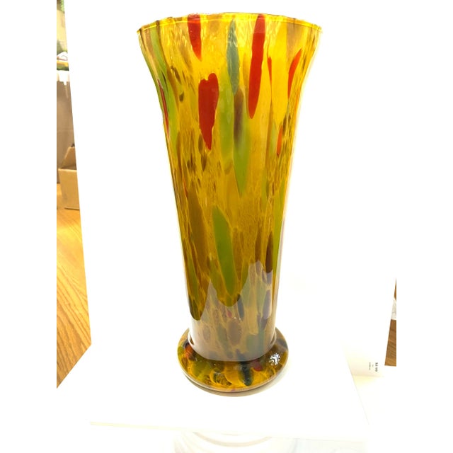A striking hand-blown Murano art glass vase made in Italy by Azzurra Maestri Vetrai, featuring warm amber tones with...