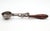 Vintage mechanical ice cream scoop historically called the ice cream disher or dipper. It features a wooden handle and a...