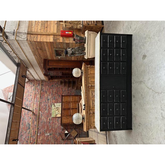 This piece of furniture has been completely restored. It features 24 functional drawers and a door in the middle that...