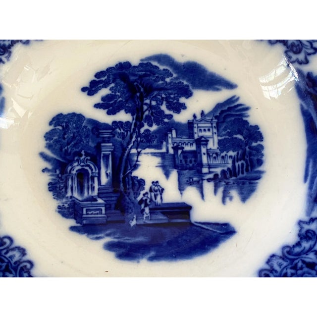 This exceptional Antique Flow Blue soup plate, stamped on the reverse with W. H. Grindley Co. England and titled...