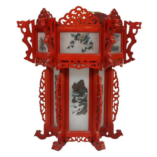 Vintage Asian red painted lantern with painted glass inserts and carved fretwork. Two tiers of lights inside