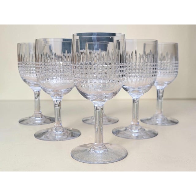 Six no. 4 cut crystal bordeaux wine glasses from the renowned baccarat crystalworks, in the nancy pattern. Created in...