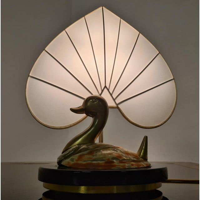 Table lamp by Antonio Pavia. Refined 80s Hollywood Regency style table lamp The lamp has a black base with brass profiles...