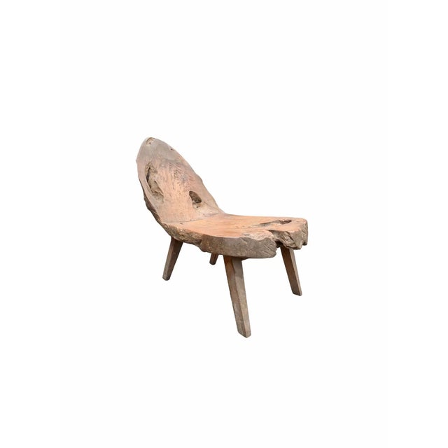 This hand-carved teak wood chair originates from the Island of Madura, off the coast of Northeastern Java. It features a...