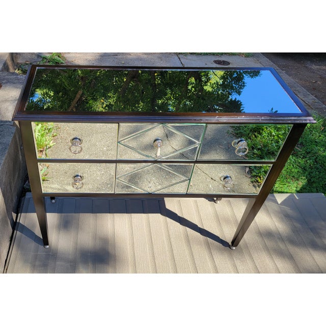 This striking, elegant mirrored console table by Maitland-Smith is made of a lacquered dark wood frame clad in diamond-...