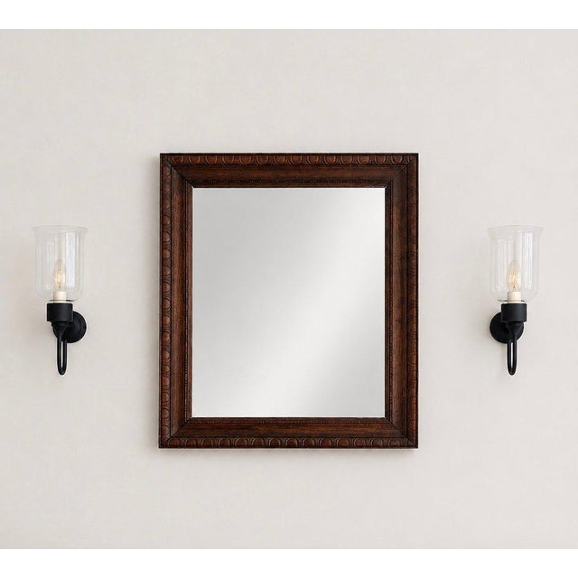 An exquisite 19th-century Biedermeier wall mirror that beautifully showcases the clean, geometric elegance and material...