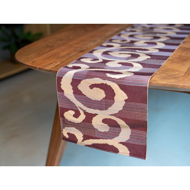 The composed swirl. The complex Jacquard lampas weave — one of the most demanding silk constructions — held here in...