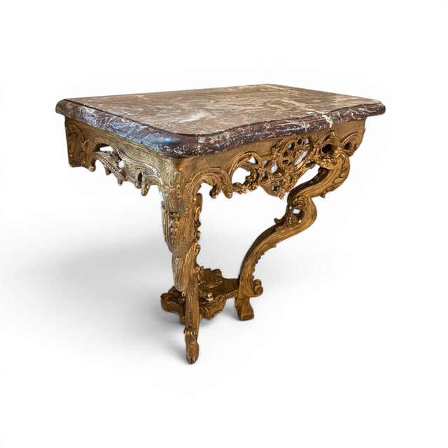This exceptional 18th century French console table features a beautifully carved and gilded frame topped with elegant...
