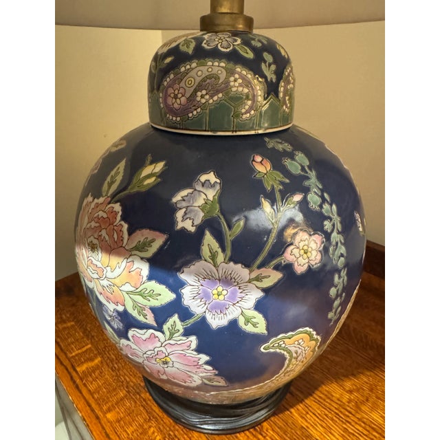 Beautiful large famille rose ginger jar lamp from Macau. Excellent vintage condition, no cracks. The shade has one tear...