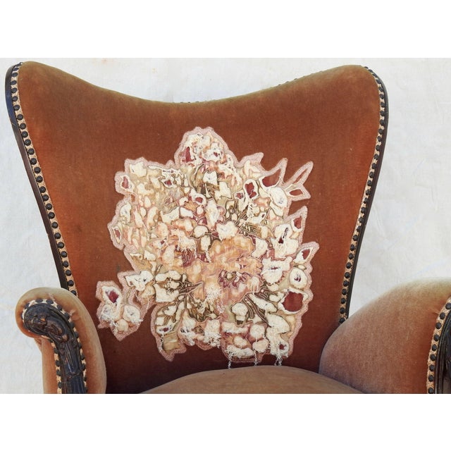 The wood carving on this wingback chair is stunning! The chair is upholstered in soft velvet and the back has an appliqued...