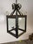 A striking pair of handcrafted wrought iron lanterns, custom made for Miamar Home, combining Old World European form with...