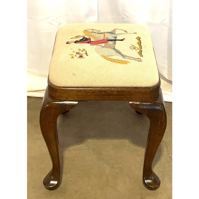 An exceptionally charming vintage Queen Anne-style footstool or small vanity bench crafted from rich walnut. The stool...