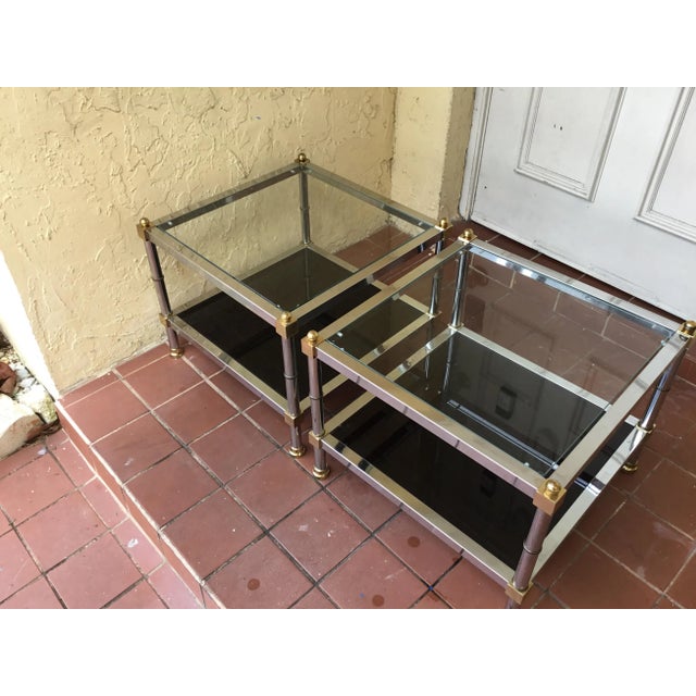 Beautiful vintage pair of side tables the tables made of chromes and brass the tops glass they are clear and bottom of the...