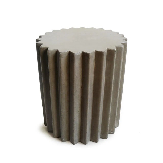 Outdoor lightweight cement resin side table with fun modern sunburst design around the outside. Simple unique piece for...