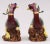 Pair of Chinese colorful polychrome glazed biscuit models of phoenix birds perched on rockwork decorated in yellow, green,...