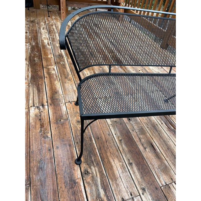 Premium mid-century outdoor style meets lasting durability in this genuine wrought iron mesh loveseat bench manufactured...