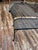 Premium mid-century outdoor style meets lasting durability in this genuine wrought iron mesh loveseat bench manufactured...